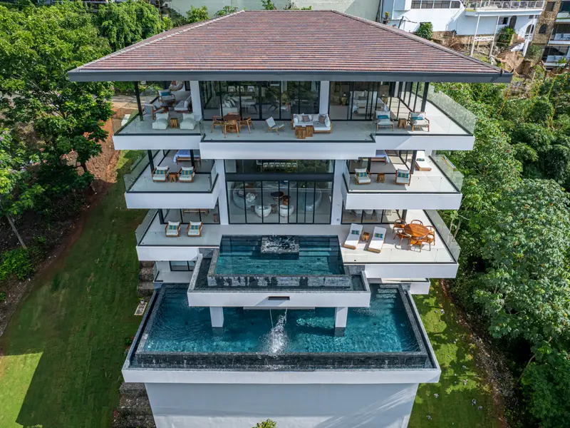 Overhead view of the villa's stacked terraces and pools
