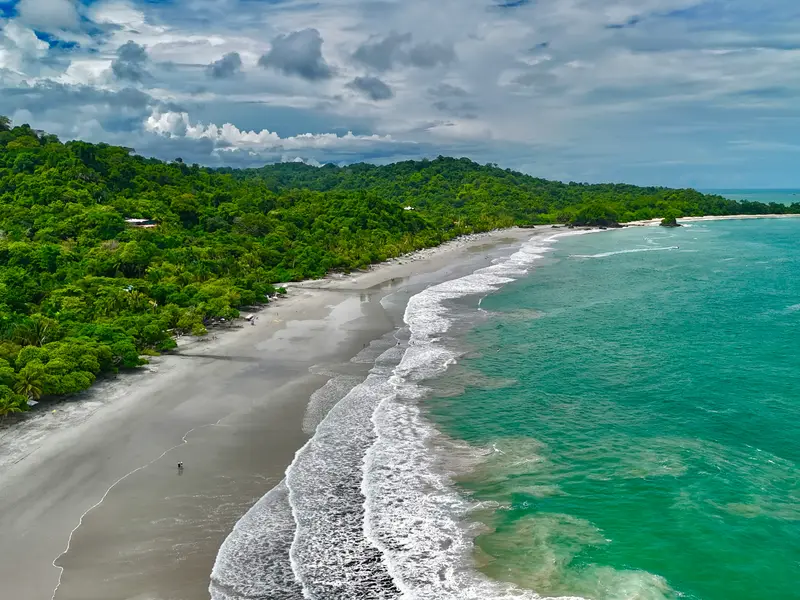 Turquoise water along a Manuel Antonio beach from above