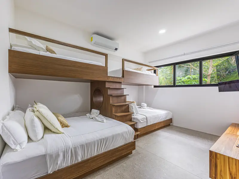 Bunk room for younger guests, with garden windows