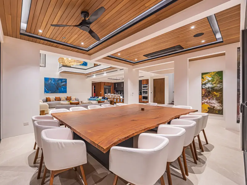 The main dining table, seating sixteen, beneath the coffered timber ceiling