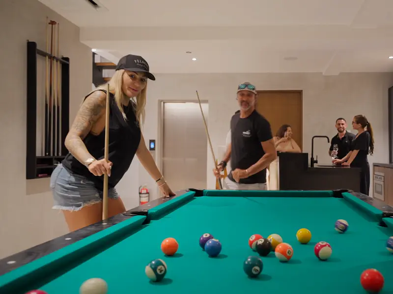 Guests playing pool in the games room