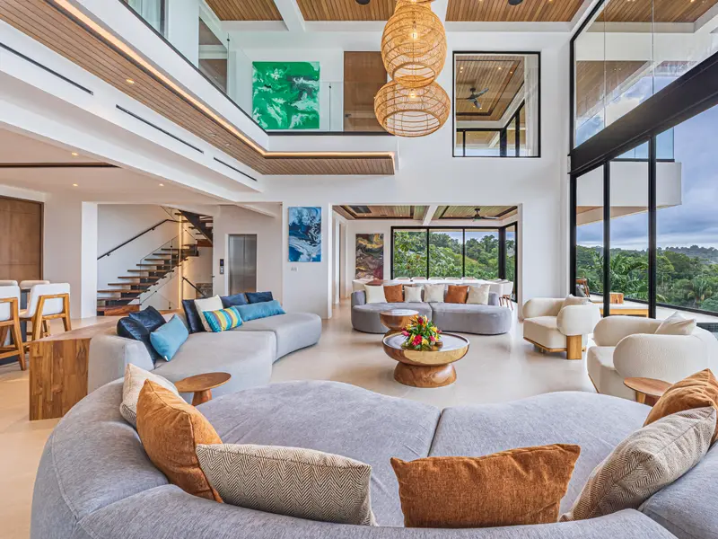 Open-plan lounge with curved seating beneath the timber ceiling