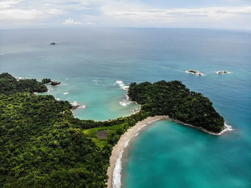 Aerial view of Manuel Antonio National Park's twin coves and Punta Catedral