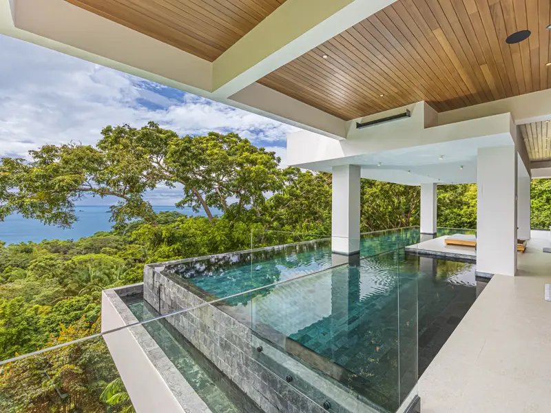 Infinity pool aligned with the horizon over the rainforest