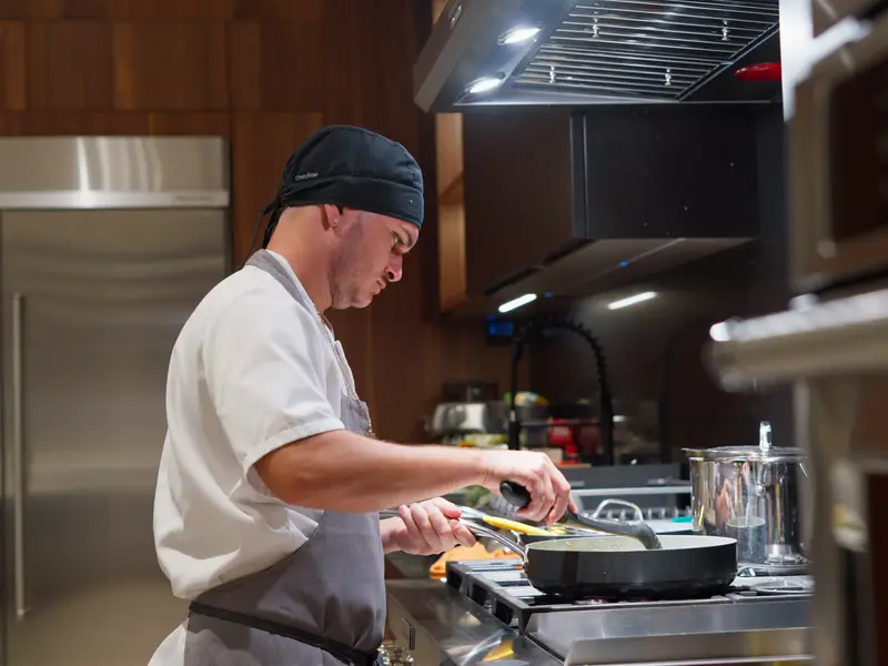 A private chef cooking in the villa's main kitchen