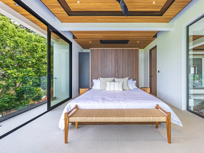 Morning light across a king bed facing the ocean