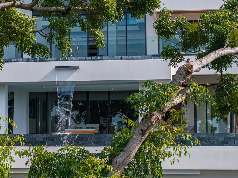 Water falling between levels against the white facade